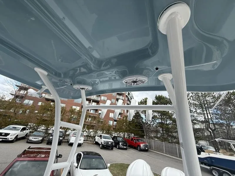 Slide: The Image of 2025 Sea Hunt Gamefish 28 Coffin Box boat interior, featuring sturdy support structures and overhead speakers. - 9