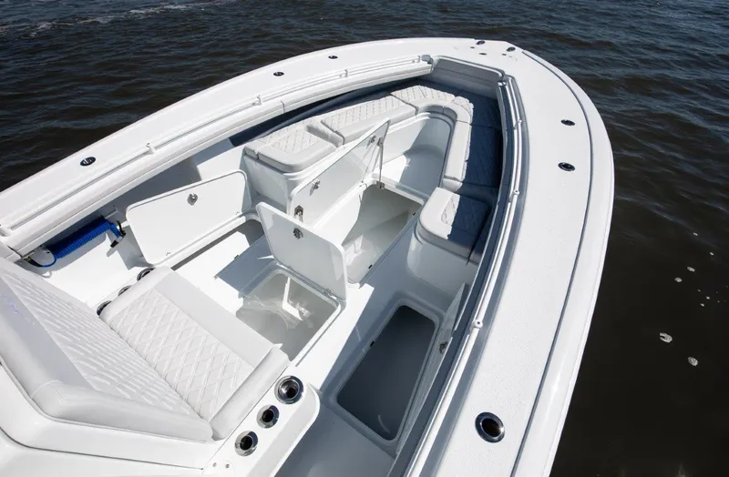 Slide: The Image of 2025 Yellowfin 32 Offshore boat interior with seating and storage, on the water. - 14
