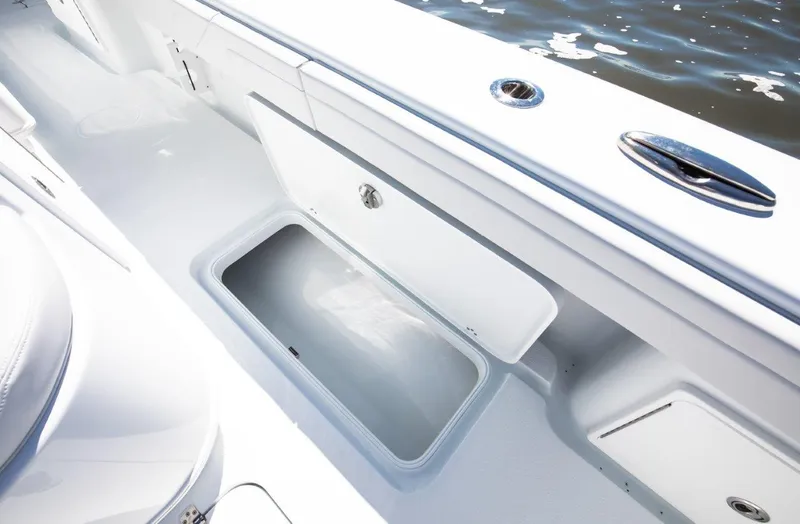 Slide: The Image of 2025 Yellowfin 32 Offshore boat interior with open storage compartment. - 15