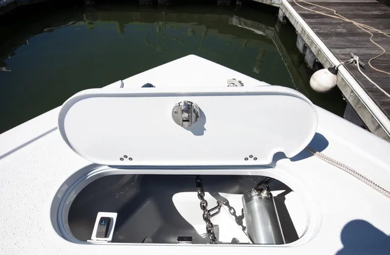 Slide: The Image of Open anchor compartment on 2025 Yellowfin 32 Offshore boat at dock. - 18