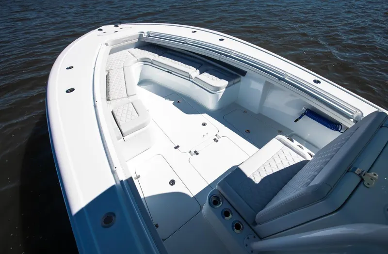 Slide: The Image of 2025 Yellowfin 32 Offshore boat with spacious seating on calm water. - 7