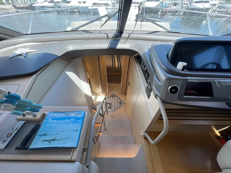 Slide: The Image of Interior view of 2018 Princess F55 yacht, featuring modern design and navigation controls. - 17