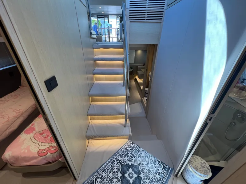 Slide: The Image of Interior of 2018 Princess F55 yacht with modern staircase and cozy cabin spaces. - 18