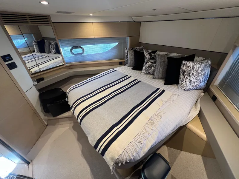 Slide: The Image of Luxurious bedroom interior of 2018 Princess F55 yacht with striped bedding and decorative pillows. - 23
