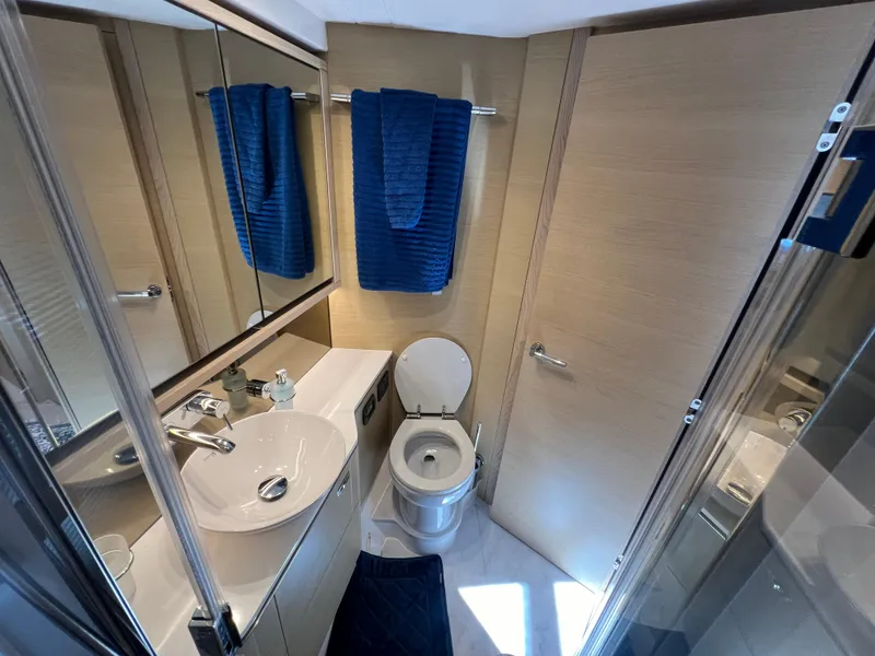 Slide: The Image of Luxurious bathroom in 2018 Princess F55 yacht with modern fixtures and blue towels. - 25