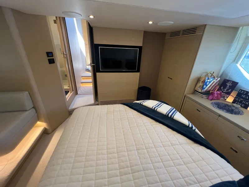 Slide: The Image of Luxurious 2018 Princess F55 yacht bedroom with TV, modern decor, and natural lighting. - 30