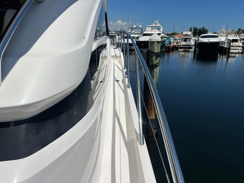 Slide: The Image of 2018 Princess F55 yacht docked at marina, clear blue sky, calm water. - 31