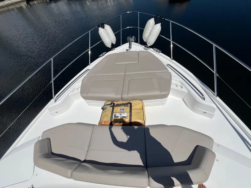 Slide: The Image of 2018 Princess F55 yacht bow with cushioned seating and life raft. - 32