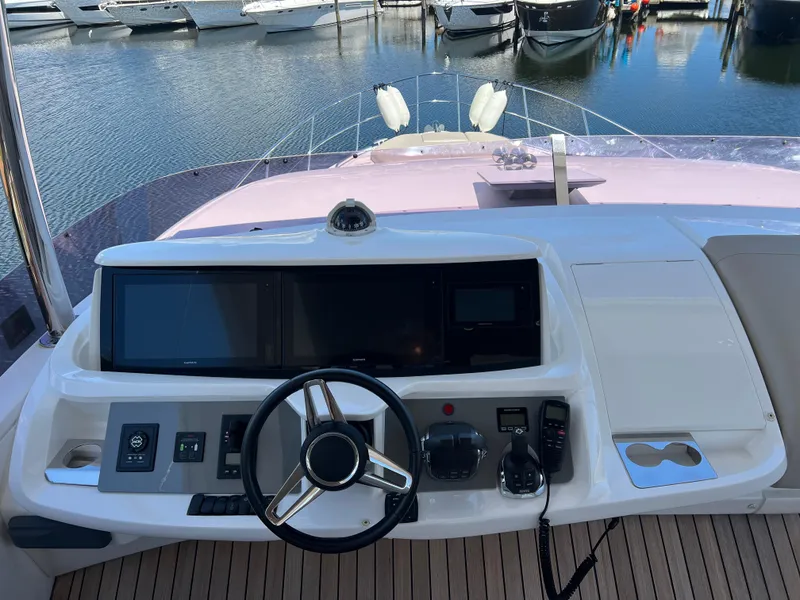 Slide: The Image of 2018 Princess F55 yacht helm with modern controls and steering wheel. - 41