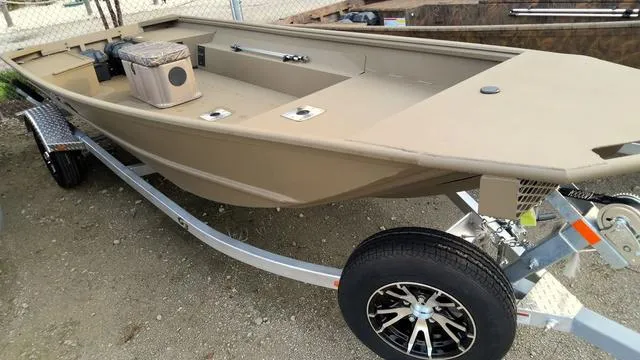 Slide: The Image of 2024 G3 16 FL boat on trailer, beige color, parked on gravel. - 2