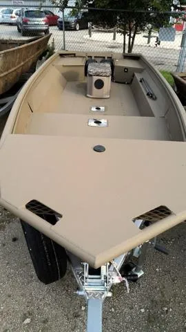 Slide: The Image of 2024 G3 16 FL boat, beige color, parked on a trailer. - 4