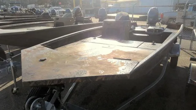 Slide: The Image of 2024 G3 17 SC boat with dual motors on display in a dealership lot. - 2