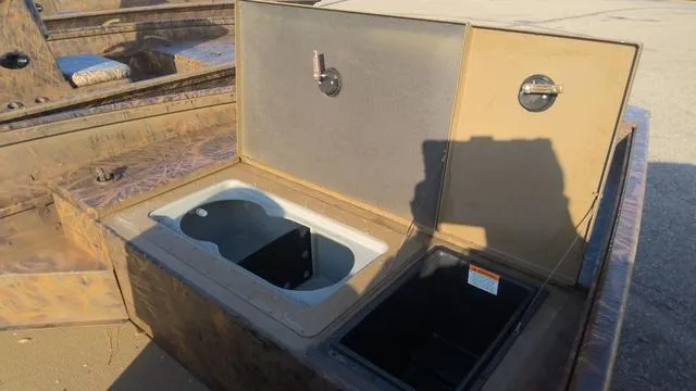 Slide: The Image of 2024 G3 17 SC boat storage compartments open under sunlight. - 3