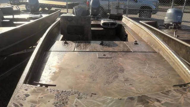 Slide: The Image of 2024 G3 17 SC boat with camouflage design, parked outdoors. - 6