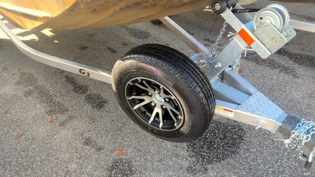 Slide: The Image of 2024 G3 17 SC boat trailer with black alloy wheel on asphalt. - 7