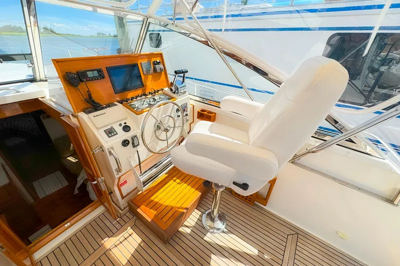 Slide: The Image of 1995 Grand Banks 38 Eastbay EX helm with white captain's chair and navigation equipment. - 10