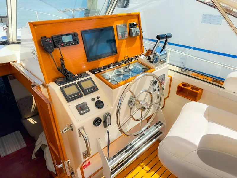 Slide: The Image of Helm of 1995 Grand Banks 38 Eastbay EX with navigation equipment and steering wheel. - 11