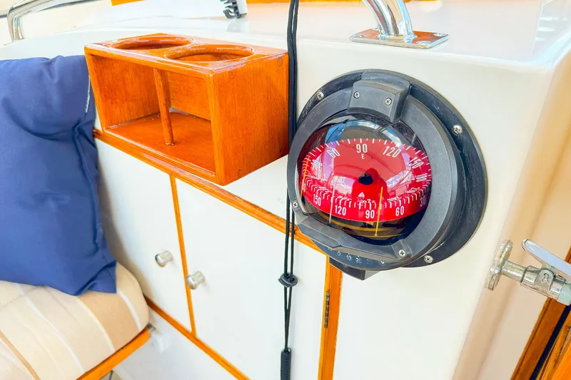 Slide: The Image of Compass on 1995 Grand Banks 38 Eastbay EX yacht, with wooden cabinetry and seating. - 14