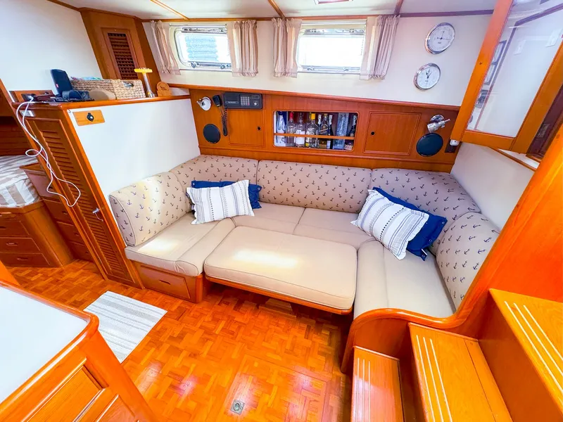 Slide: The Image of Cozy interior of 1995 Grand Banks 38 Eastbay EX with plush seating and nautical decor. - 26