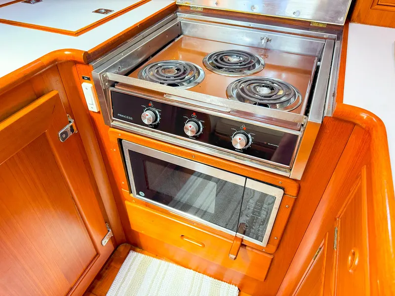 Slide: The Image of 1995 Grand Banks 38 Eastbay EX galley with stove and microwave. - 29