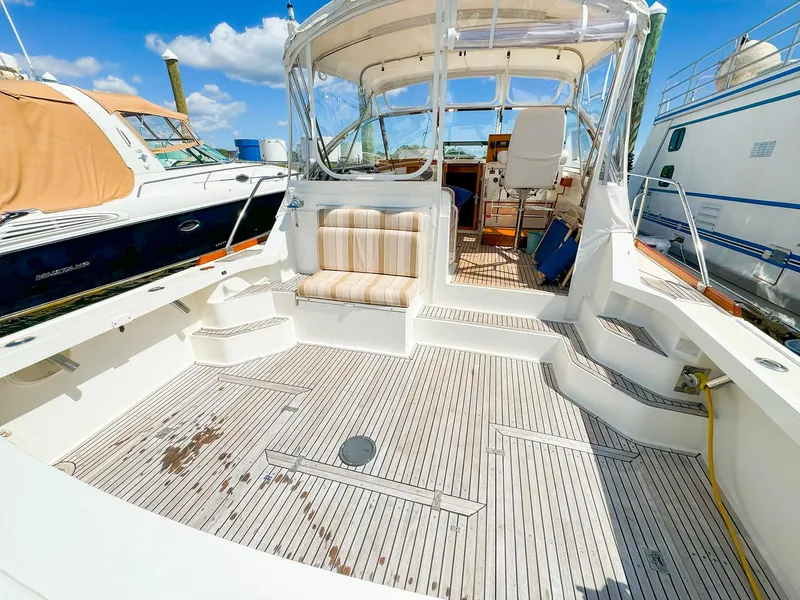 Slide: The Image of 1995 Grand Banks 38 Eastbay EX yacht with spacious deck and seating area. - 3