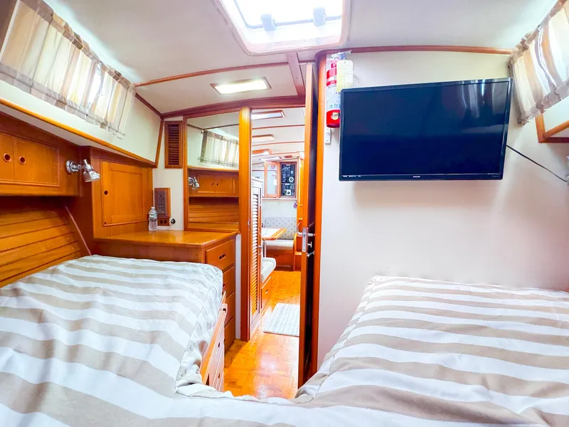 Slide: The Image of Interior of 1995 Grand Banks 38 Eastbay EX with twin beds and TV. - 31