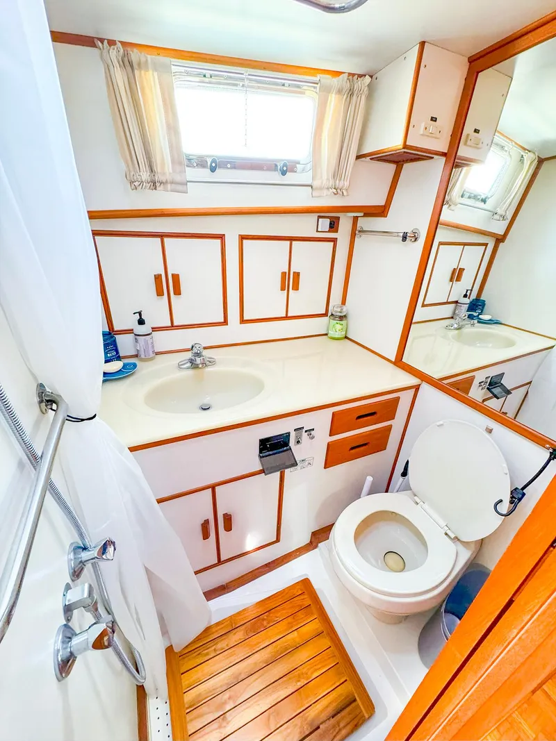 Slide: The Image of 1995 Grand Banks 38 Eastbay EX bathroom with wood accents and white fixtures. - 33