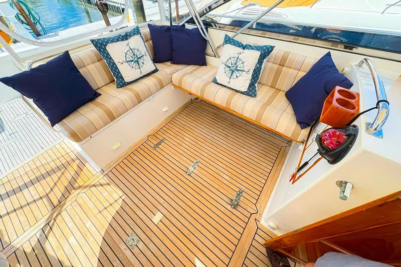 Slide: The Image of Cozy seating area on 1995 Grand Banks 38 Eastbay EX yacht with nautical-themed cushions. - 8