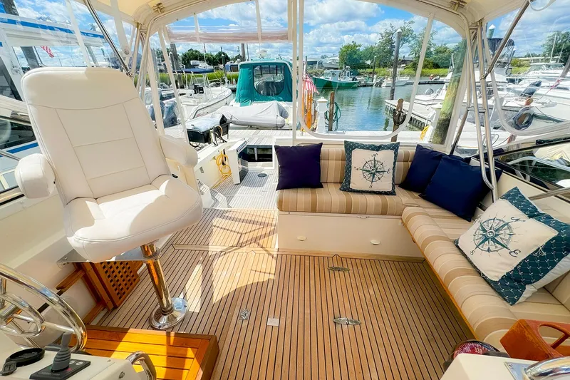 Slide: The Image of 1995 Grand Banks 38 Eastbay EX yacht interior with plush seating and nautical decor. - 9