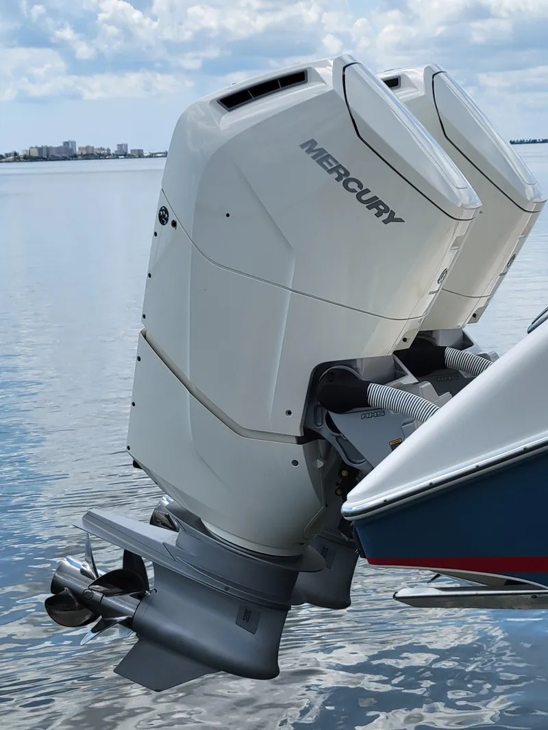 Slide: The Image of 2023 Solace 41 CS boat with dual Mercury outboard engines on calm water. - 13