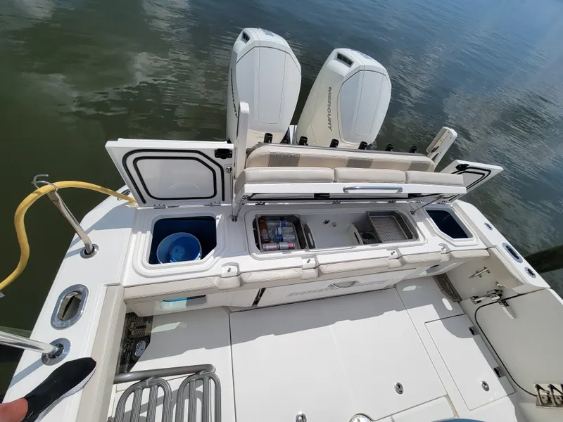 Slide: The Image of 2023 Solace 41 CS boat with open storage compartments and twin engines. - 15