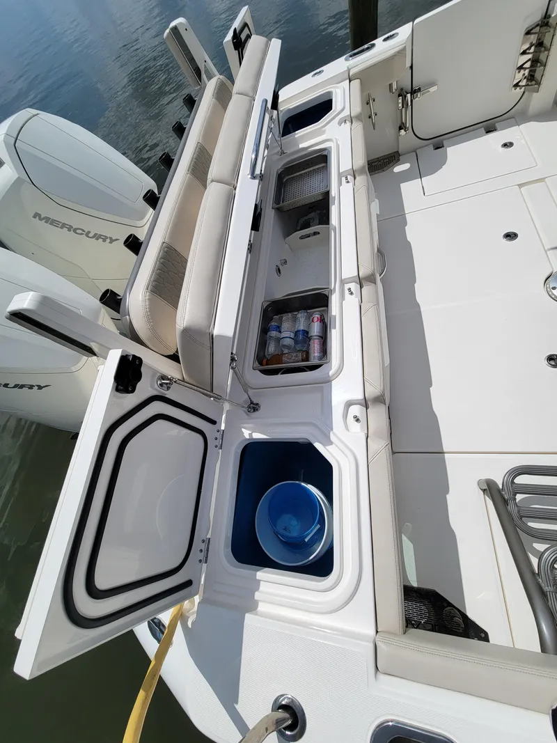 Slide: The Image of 2023 Solace 41 CS boat deck with storage compartments and Mercury engines. - 16