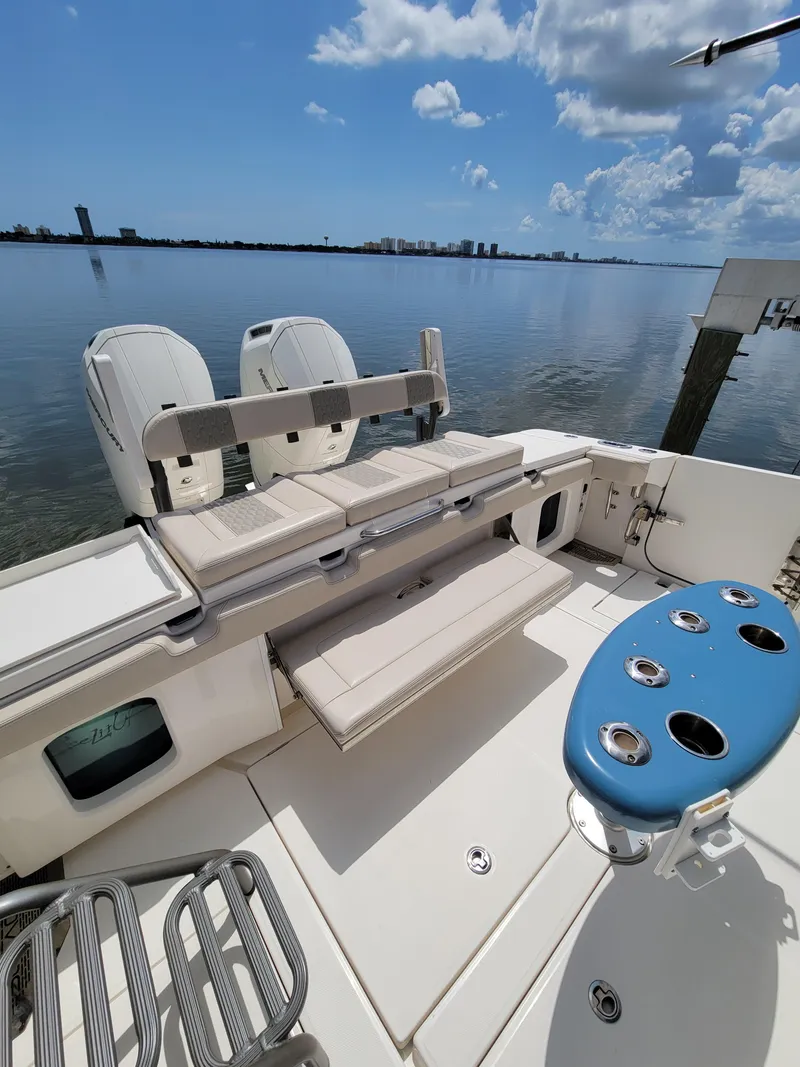 Slide: The Image of 2023 Solace 41 CS boat deck with seating, rod holders, and scenic water view. - 17