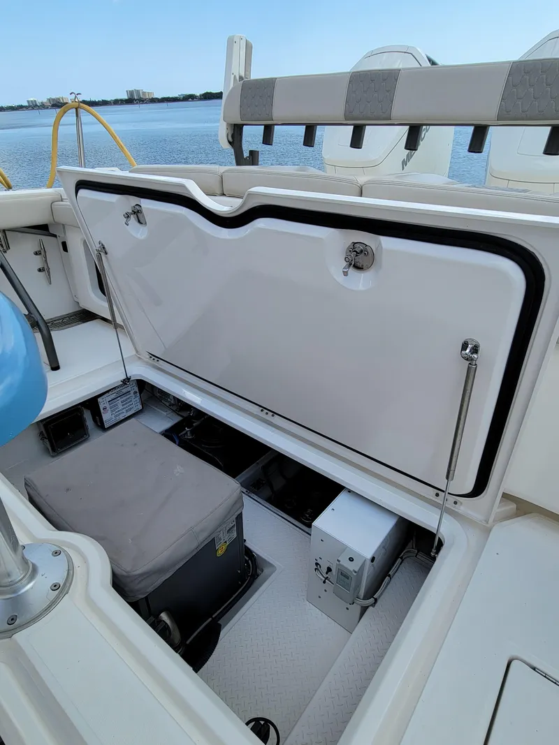 Slide: The Image of 2023 Solace 41 CS boat storage compartment with open hatch, docked by the water. - 23