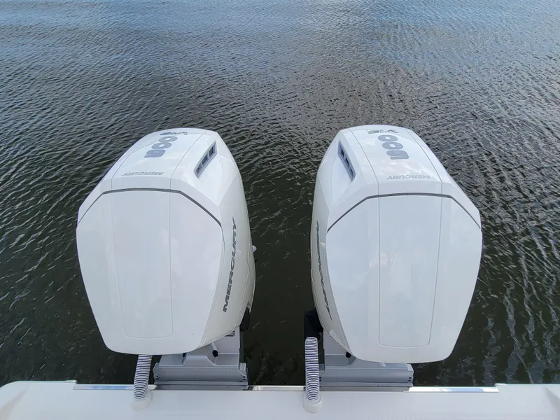Slide: The Image of Twin outboard engines on 2023 Solace 41 CS boat, on calm water. - 24