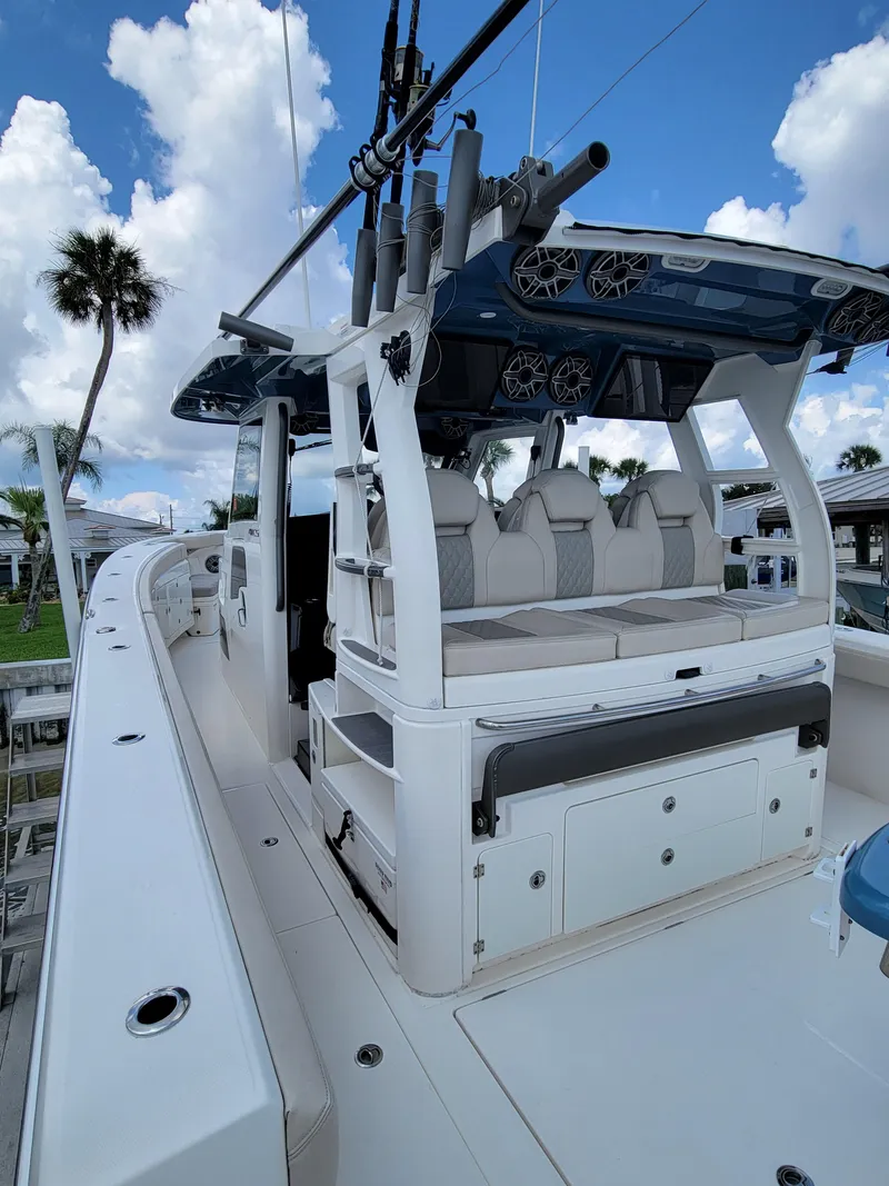 Slide: The Image of 2023 Solace 41 CS boat with sleek design and modern features, docked under blue skies. - 25