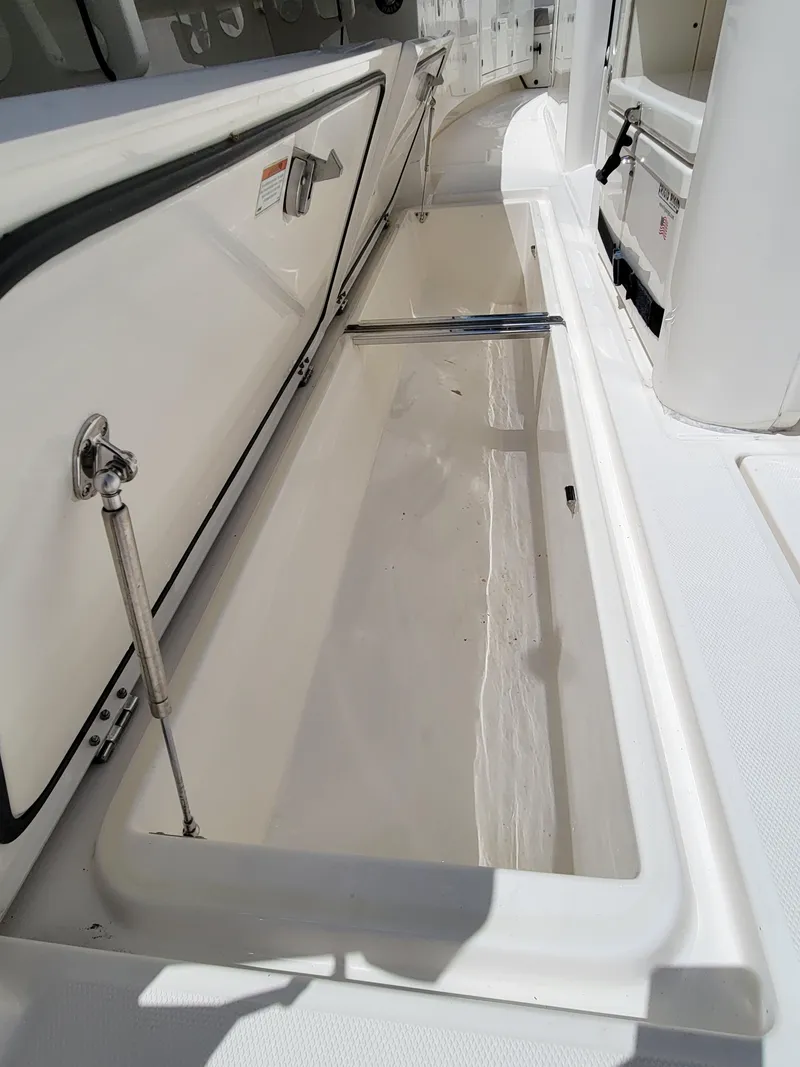 Slide: The Image of 2023 Solace 41 CS boat storage compartment with open lid. - 27