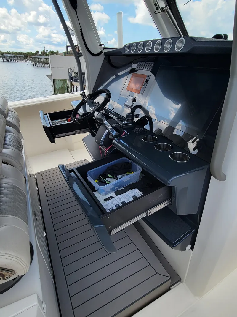 Slide: The Image of 2023 Solace 41 CS boat cockpit with advanced navigation controls and storage drawers. - 31