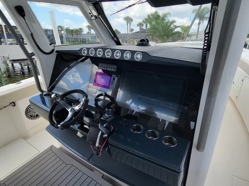 Slide: The Image of 2023 Solace 41 CS boat cockpit with modern navigation controls and dual steering wheels. - 32