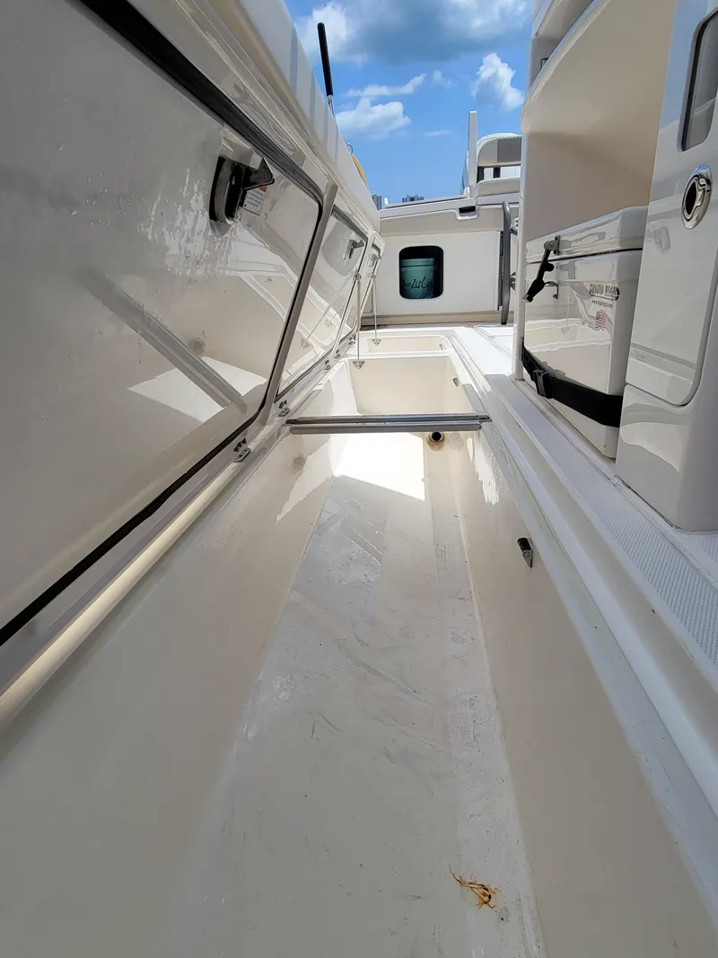 Slide: The Image of 2023 Solace 41 CS boat interior with sleek white design and storage compartments. - 35