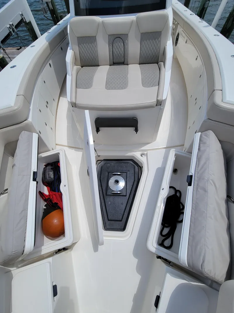 Slide: The Image of 2023 Solace 41 CS boat interior with open storage compartments and cushioned seating. - 47