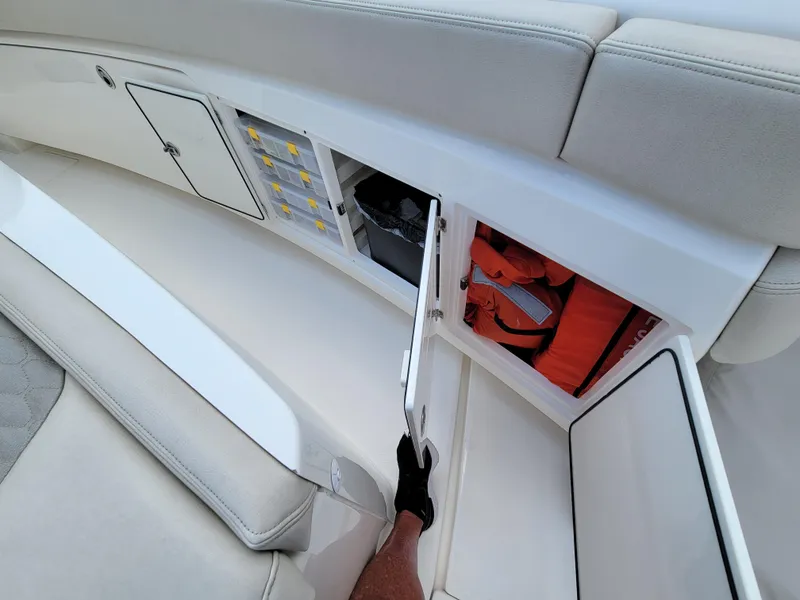 Slide: The Image of 2023 Solace 41 CS boat storage compartments with safety equipment and controls. - 48