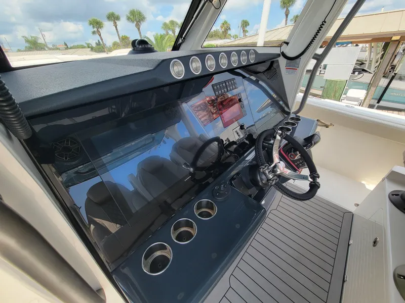 Slide: The Image of 2023 Solace 41 CS boat dashboard with modern controls and steering wheel. - 6