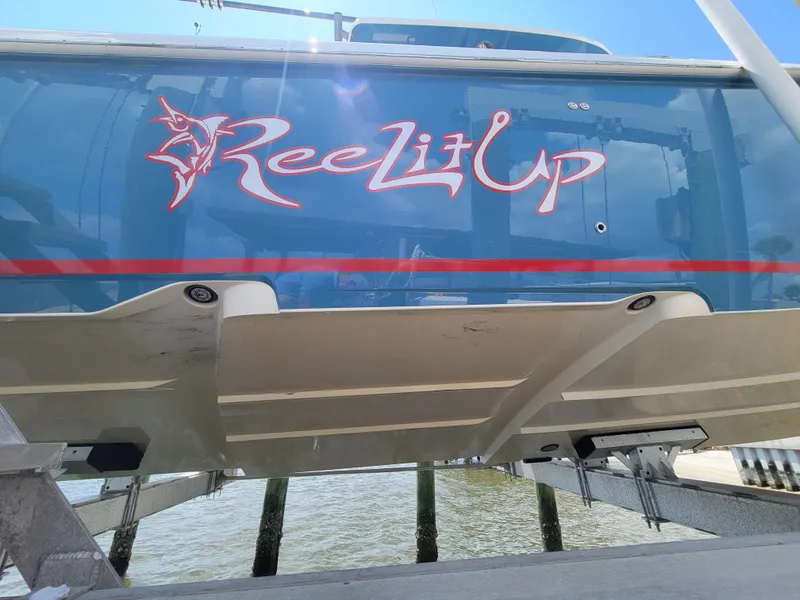 Slide: The Image of 2023 Solace 41 CS boat with "Reel Lit Up" logo on blue hull. - 8
