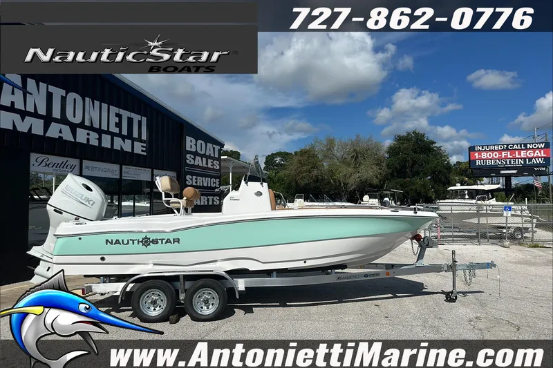 The Image of 2025 NauticStar 211 Hybrid boat on trailer at Antonietti Marine dealership. - 1