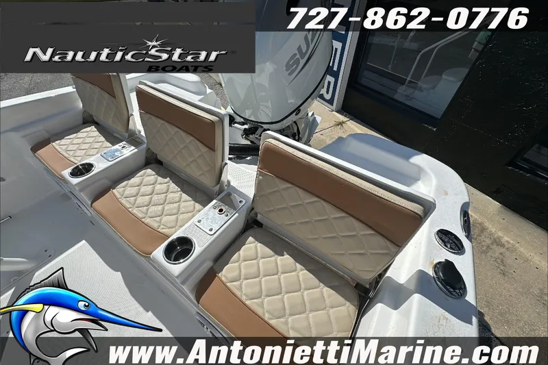 Slide: The Image of 2025 NauticStar 211 Hybrid boat interior with cushioned seats and cup holders. - 13