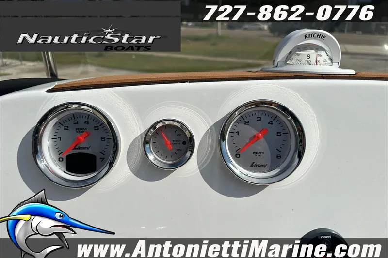 Slide: The Image of Dashboard of 2025 NauticStar 211 Hybrid boat with gauges and compass. - 17