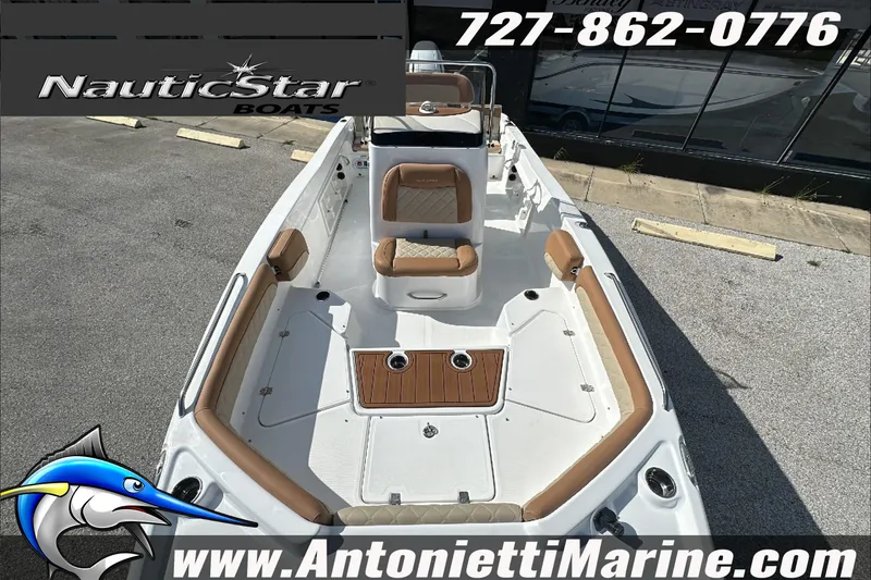 Slide: The Image of 2025 NauticStar 211 Hybrid boat with tan seating, displayed at Antonietti Marine. - 24