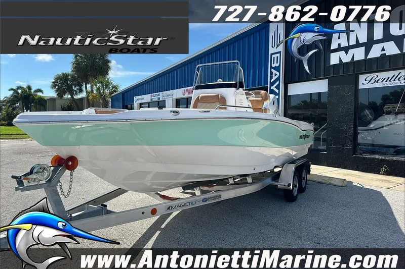 Slide: The Image of 2025 NauticStar 211 Hybrid boat on trailer at Antonietti Marine dealership. - 4