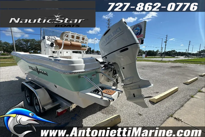 Slide: The Image of 2025 NauticStar 211 Hybrid boat on trailer, displayed at Antonietti Marine dealership. - 6